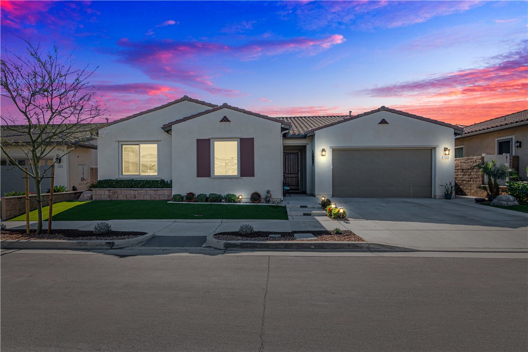 11523 Explorer Court Corona, CA 92883 - Photo 37 of 64 a front view of a house with a yard and garage