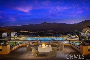 11523 Explorer Court Corona, CA 92883 - Photo 52 of 64 a view of a swimming pool with a table and chairs