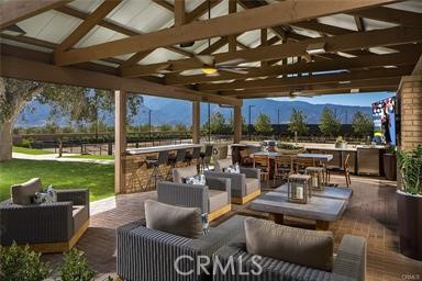 11523 Explorer Court Corona, CA 92883 - Photo 59 of 64 a view of a patio with couches chairs dining table and chairs with wooden floor
