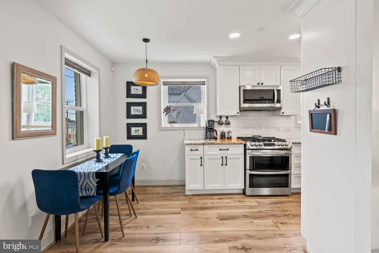 819 Chillum Road Hyattsville, MD 20783 - Photo 8 of 48 a kitchen with stainless steel appliances kitchen island granite countertop a stove top oven a sink a dining table and chairs