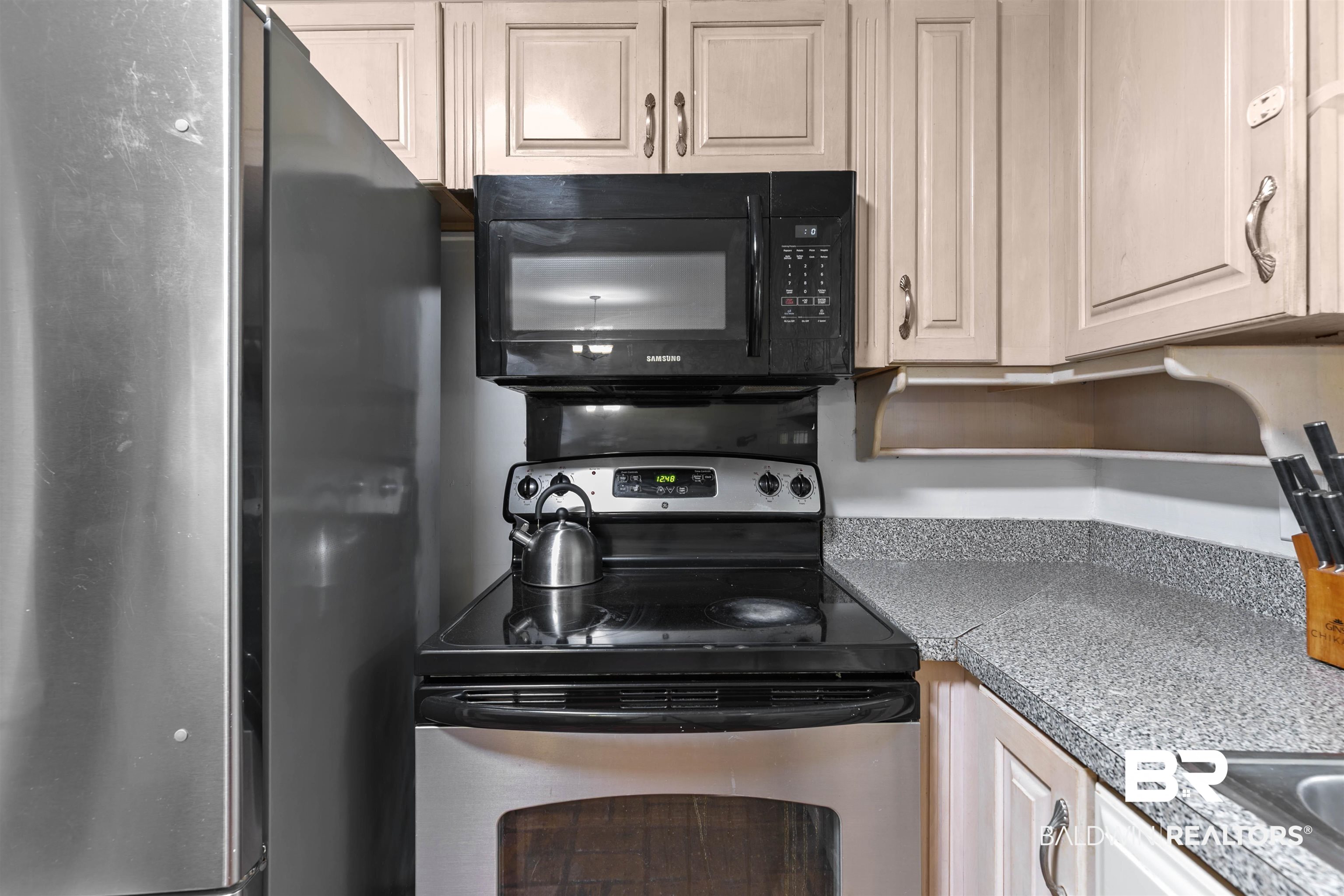 10420 Johnson Road South Mobile, AL 36695 - Photo 24 of 75 Kitchen featuring a stainless steel refrigerator, black over-the-range microwave, and a black electric range with a stainless steel oven
