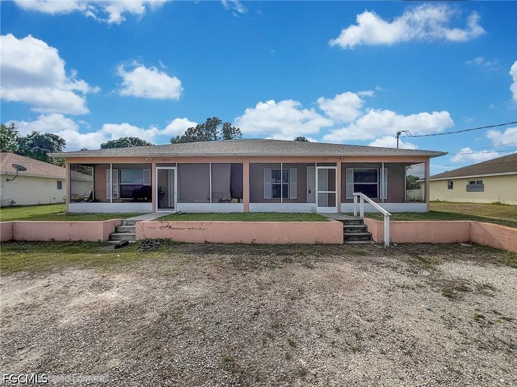 5231 27th Street Southwest Lehigh Acres, FL 33973 - Photo 5 of 22 a view of a house with a yard in front of it