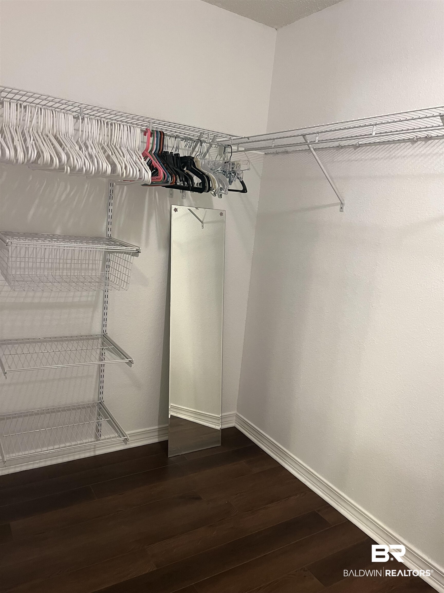 309 Cluster Street Foley, AL 36535 - Photo 19 of 38 Walk-in closet with wire shelving system, wire drawers, and dark wood-finish flooring