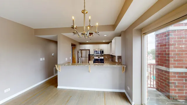 a kitchen with granite countertop a sink a stove and cabinets