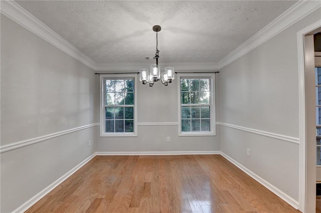 310 Andrew Ridge Drive Jefferson, GA 30549 - Photo 13 of 52 a view of an empty room with wooden floor and a window