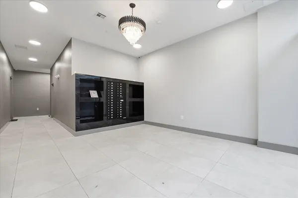 a view of an empty room with a kitchen