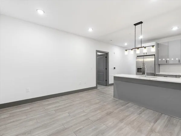 a view of a kitchen with a sink and wooden floor