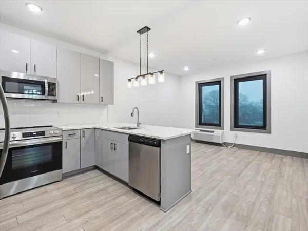 a kitchen with stainless steel appliances granite countertop a sink and a stove top oven