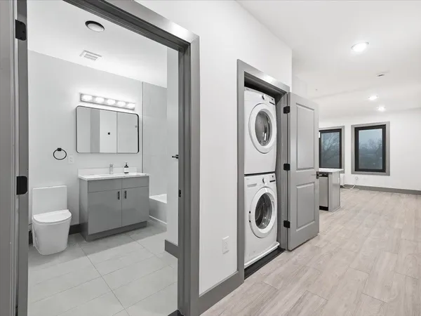 a spacious bathroom with a toilet a sink and a mirror