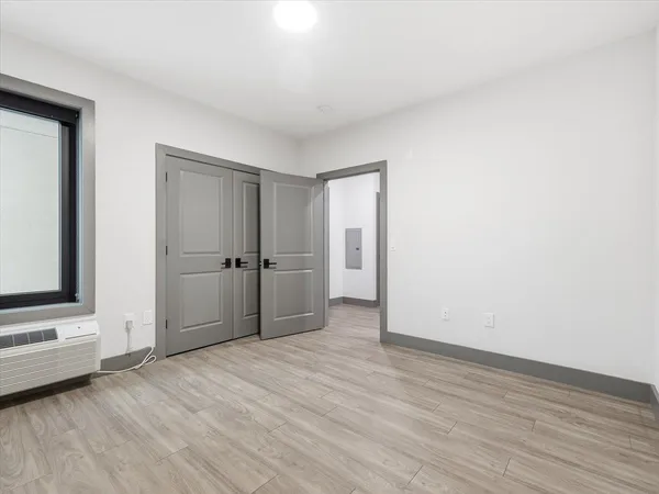 a view of an empty room and wooden floor