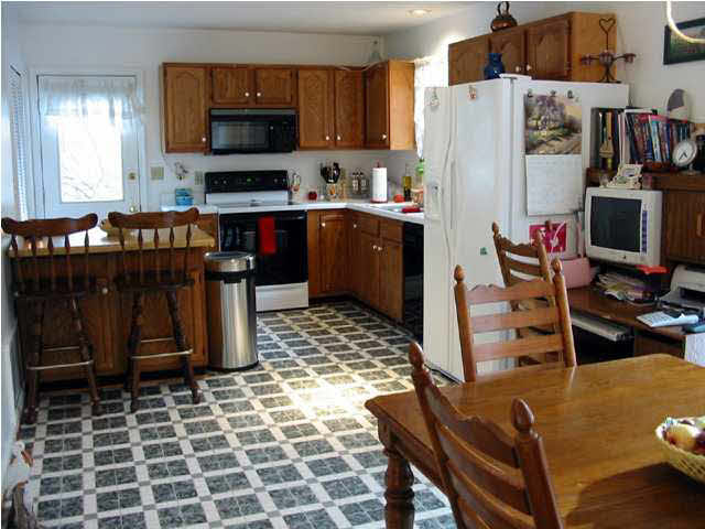 1 Tanglewood Road Palmyra, VA 22963 - Photo 3 of 7 a kitchen with stainless steel appliances a refrigerator and a stove top oven