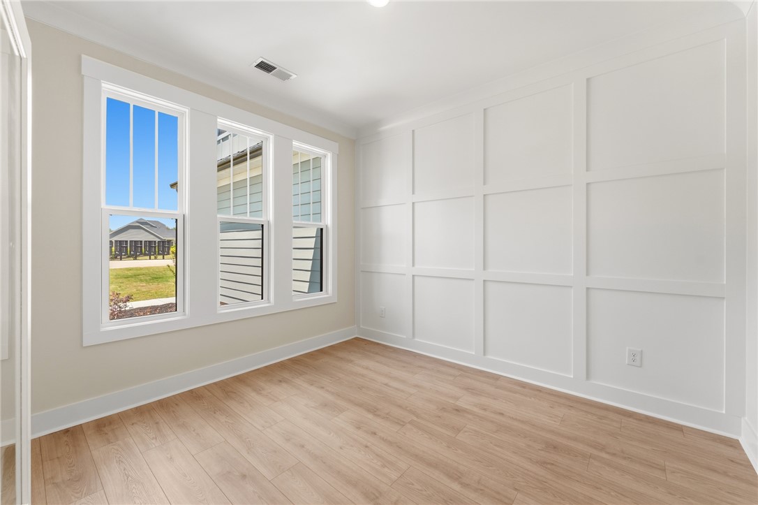 203 Timothy Court Anderson, SC 29621 - Photo 3 of 40 Board and batten detailing elevates this well-lit room, featuring durable hardwood flooring and ample natural light.