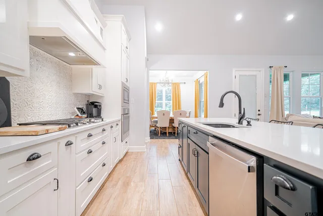 a large kitchen with cabinets a sink and appliances