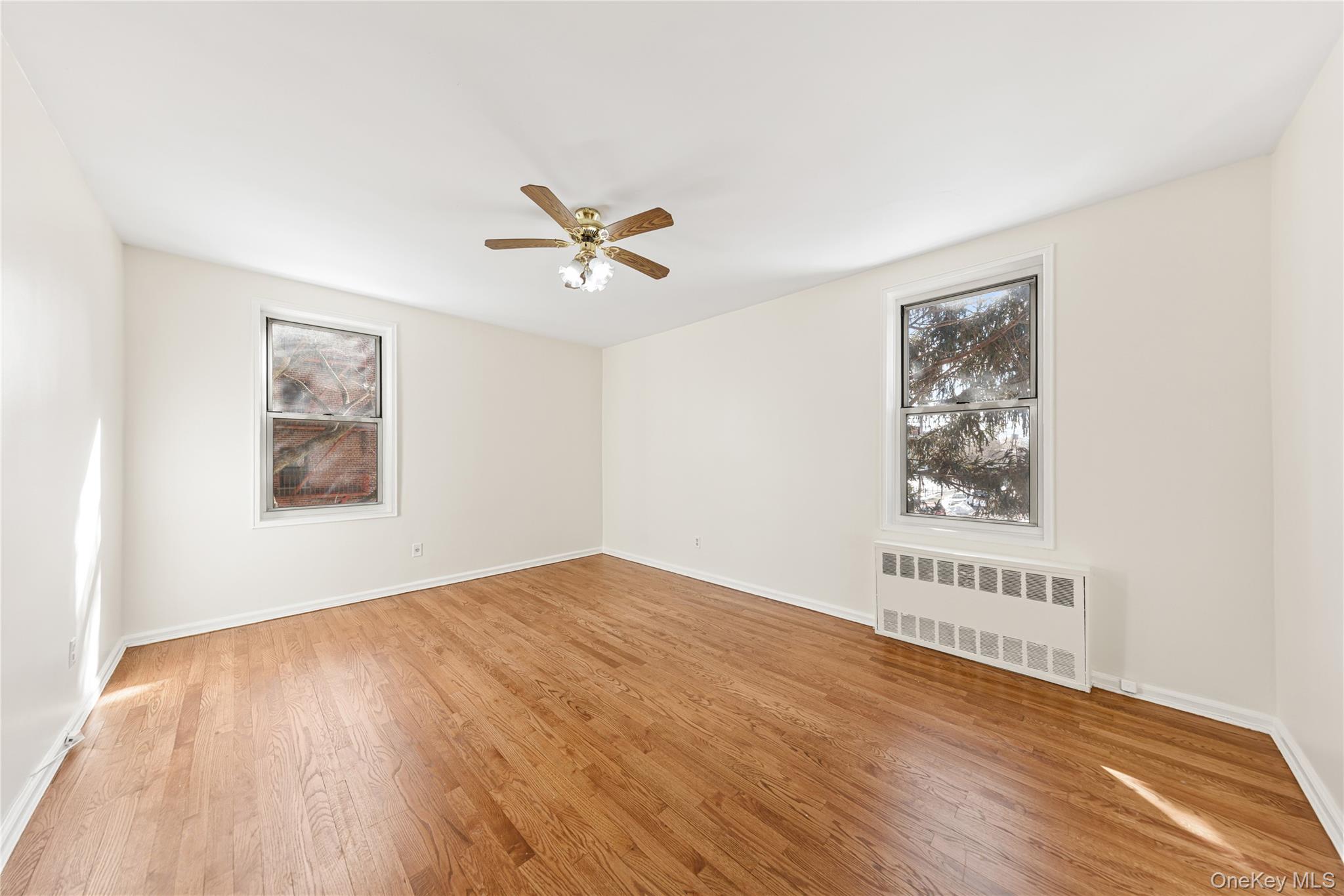 126 Church Street, Unit 2D New Rochelle, NY 10805 - Photo 11 of 32 a view of an empty room with window and wooden floor