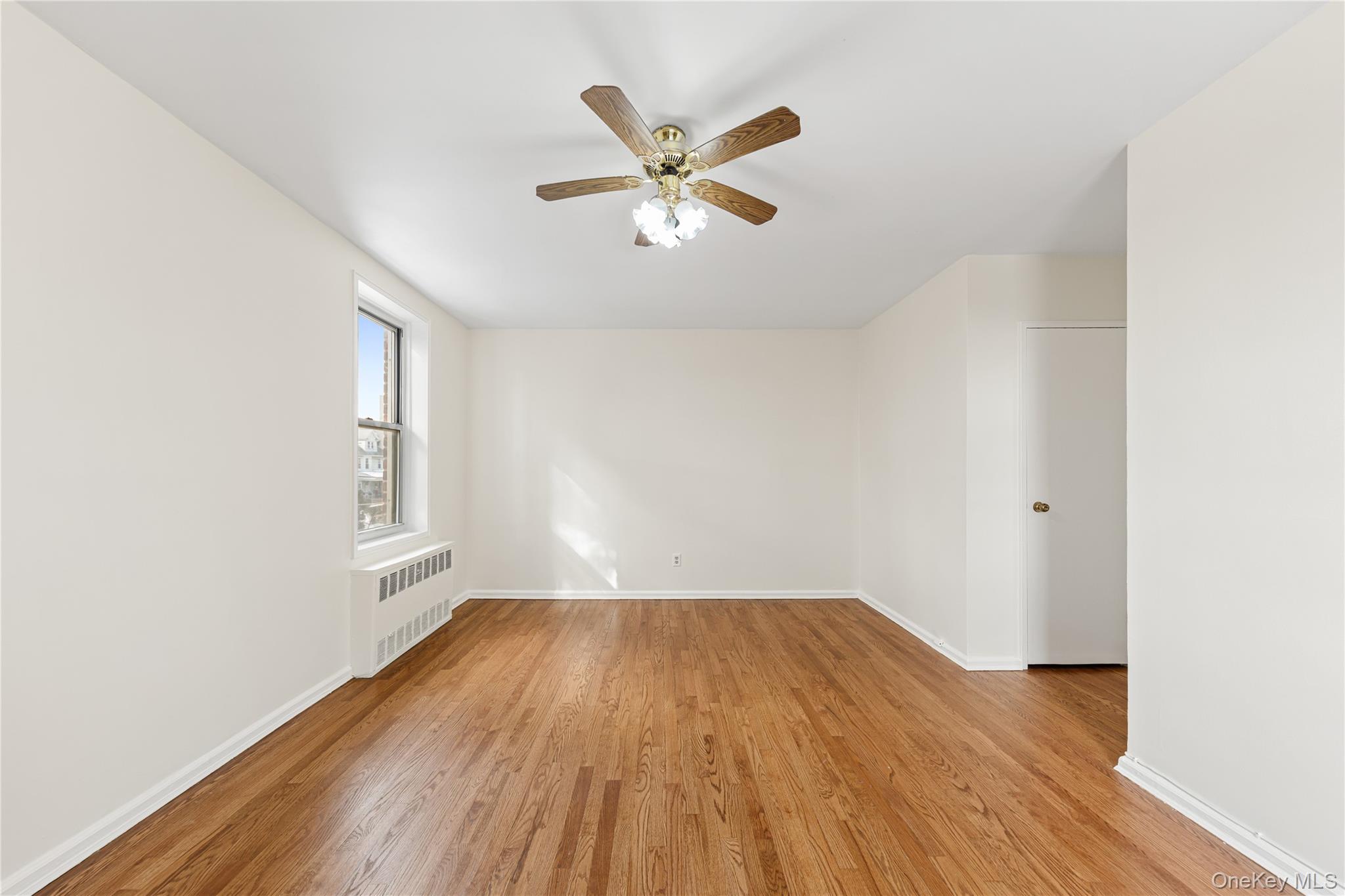 126 Church Street, Unit 2D New Rochelle, NY 10805 - Photo 14 of 32 wooden floor in an empty room with a window