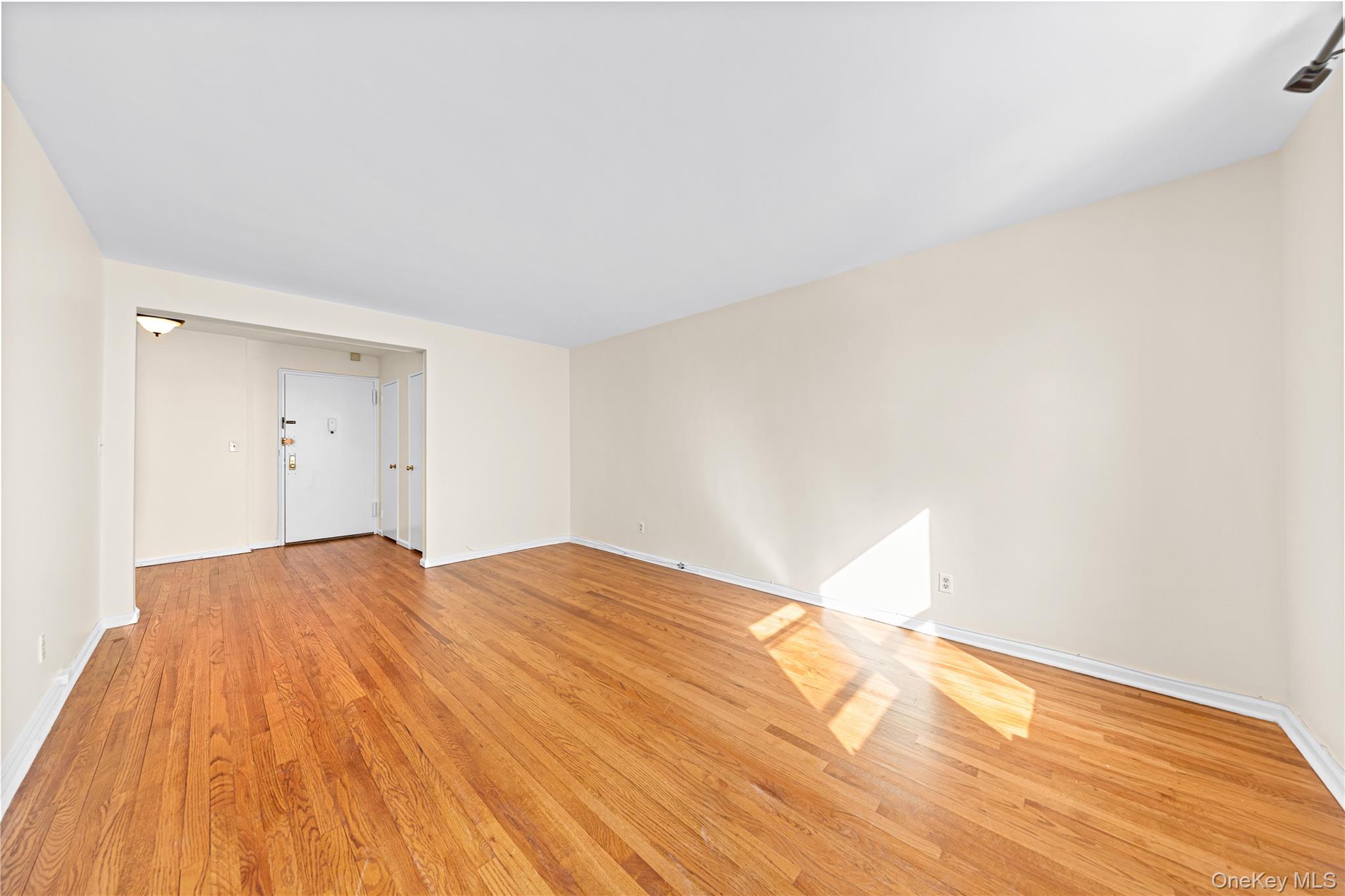 126 Church Street, Unit 2D New Rochelle, NY 10805 - Photo 2 of 32 a view of empty room with wooden floor and fan