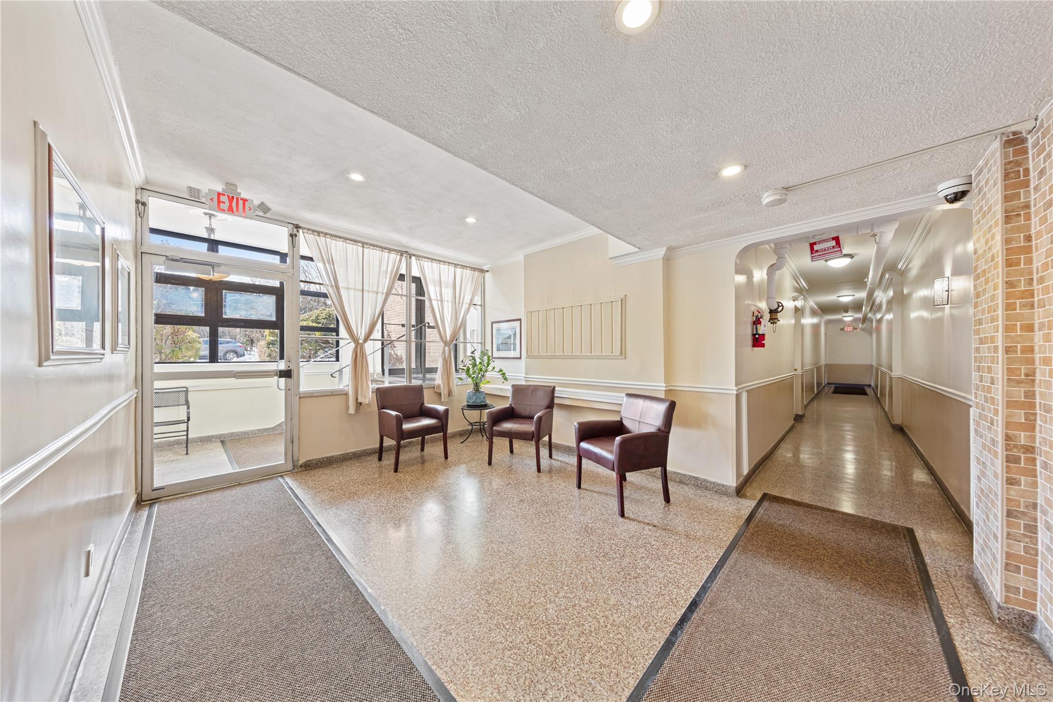 126 Church Street, Unit 2D New Rochelle, NY 10805 - Photo 24 of 32 a living room with furniture a dining table and a large window