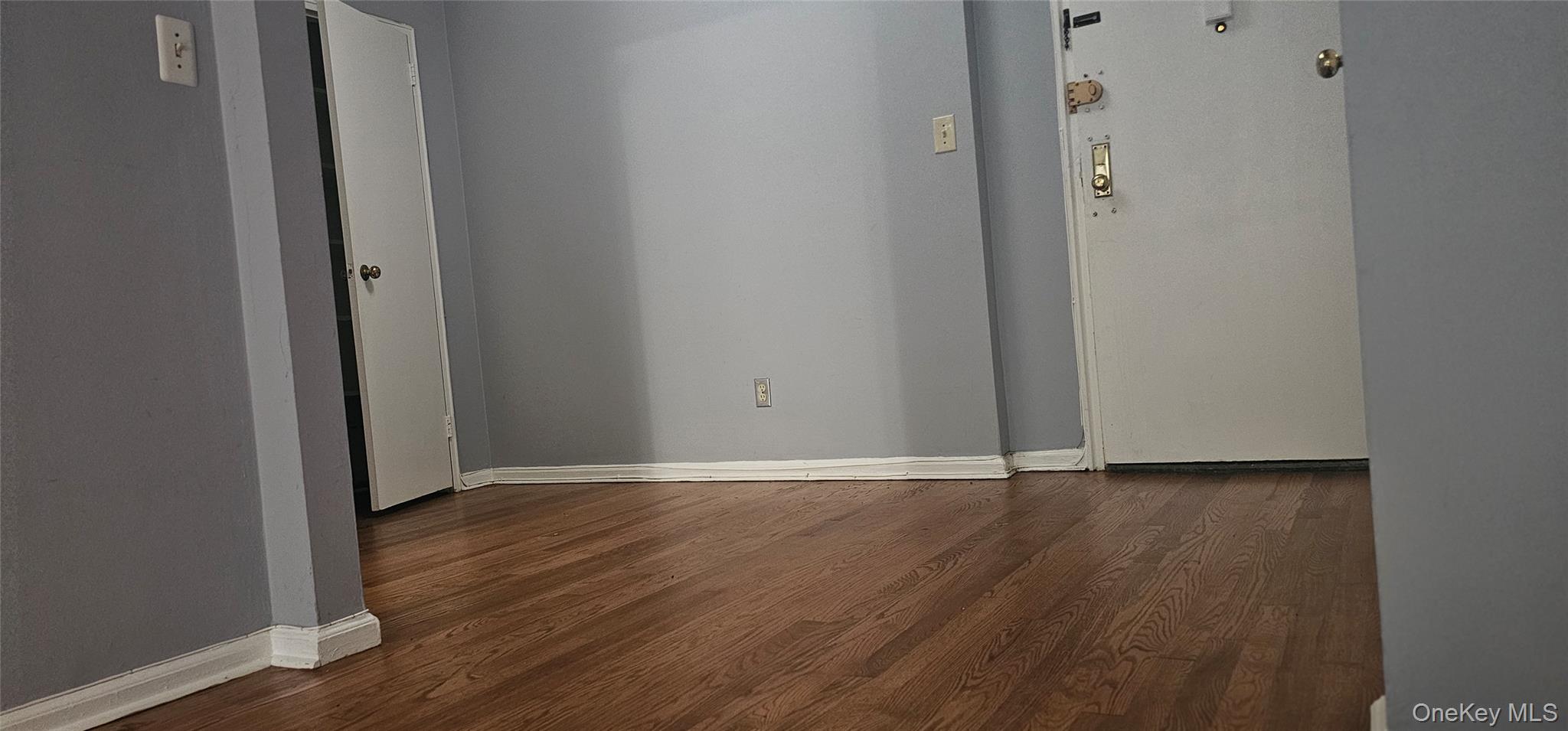 126 Church Street, Unit 2D New Rochelle, NY 10805 - Photo 5 of 15 Unfurnished room featuring dark wood finished floors and baseboards
