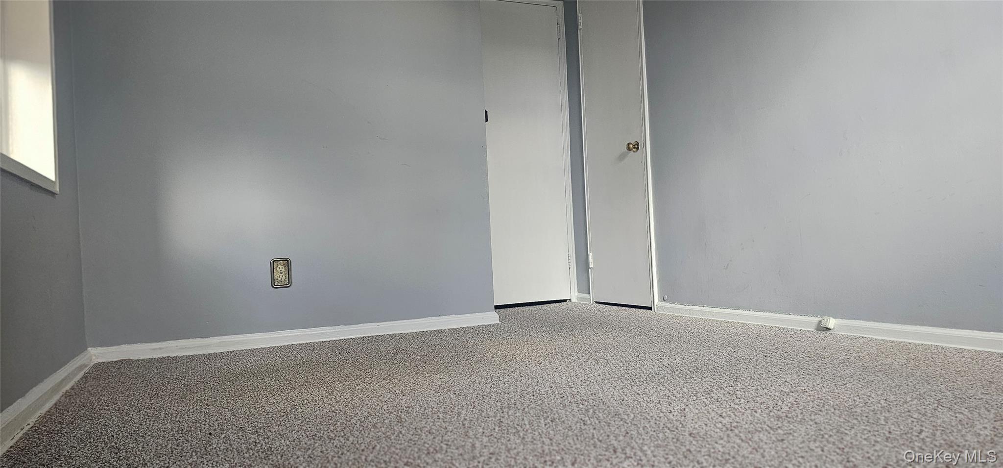 126 Church Street, Unit 2D New Rochelle, NY 10805 - Photo 9 of 15 Empty room featuring baseboards and carpet flooring