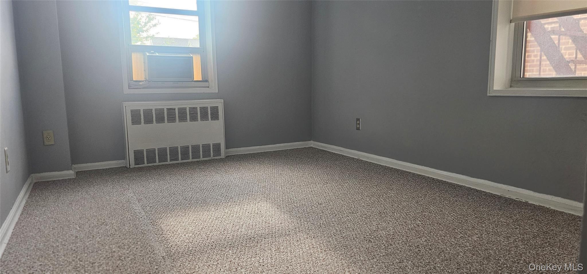 126 Church Street, Unit 2D New Rochelle, NY 10805 - Photo 10 of 15 Spare room featuring radiator and baseboards