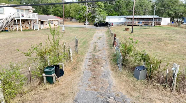a view of a swimming pool with a patio and a yard