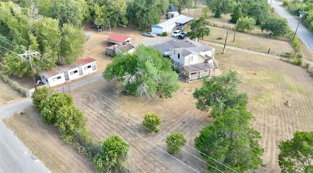 an aerial view of a house with a yard