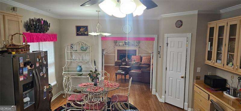 3715 Millers Pond Way Southwest Snellville, GA 30039 - Photo 12 of 13 a view of a dining room with furniture a chandelier and wooden floor