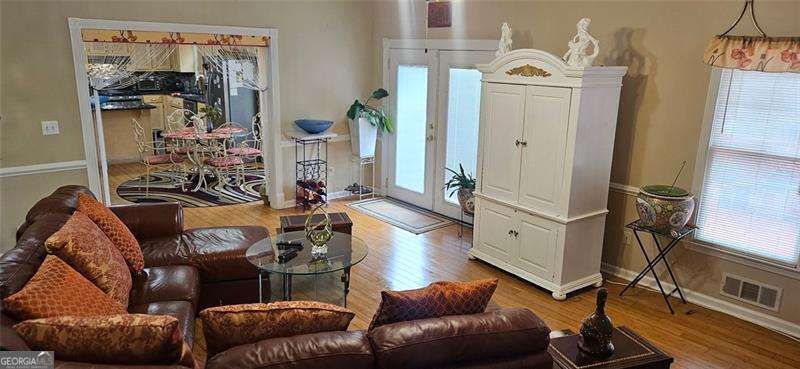 3715 Millers Pond Way Southwest Snellville, GA 30039 - Photo 2 of 13 a living room with furniture and a flat screen tv