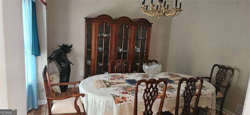 3715 Millers Pond Way Southwest Snellville, GA 30039 - Photo 3 of 13 a bedroom with a bed a chandelier and a closet