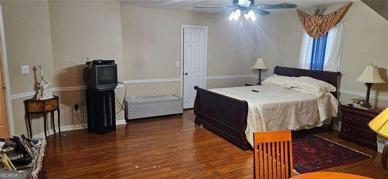 3715 Millers Pond Way Southwest Snellville, GA 30039 - Photo 5 of 13 a bedroom with a bed and wooden floor