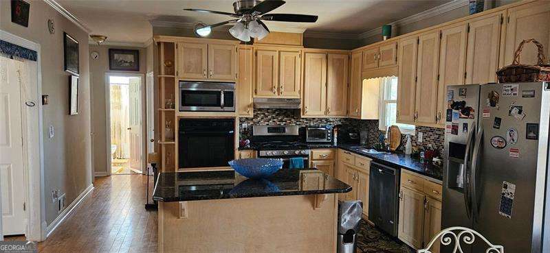 3715 Millers Pond Way Southwest Snellville, GA 30039 - Photo 7 of 13 a kitchen with stainless steel appliances a refrigerator a stove a sink and a refrigerator with wooden floor