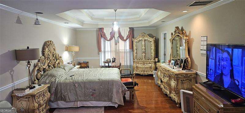 3715 Millers Pond Way Southwest Snellville, GA 30039 - Photo 9 of 13 a bedroom with furniture and a wooden floor