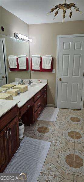 3715 Millers Pond Way Southwest Snellville, GA 30039 - Photo 10 of 13 a spacious bathroom with a sink vanity and mirror