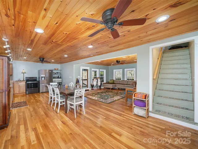 a bedroom with a large bed and wooden floor