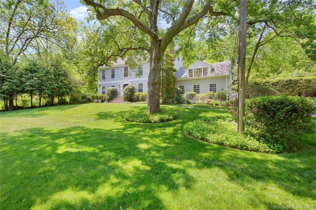 a yellow house in middle of the forest