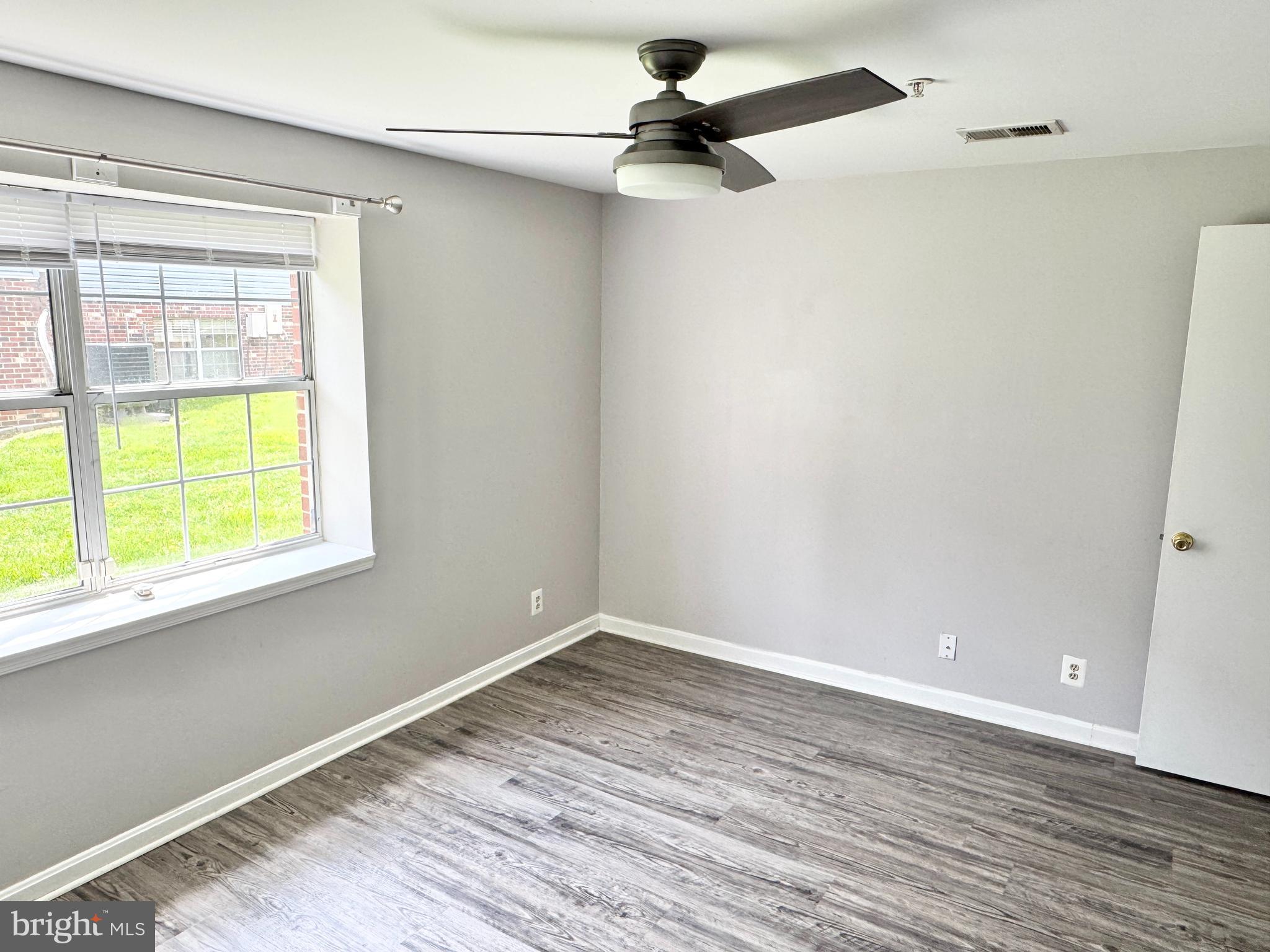 202 Dover Place, Unit 2 Stafford, VA 22556 - Photo 16 of 22 wooden floor in an empty room with a window