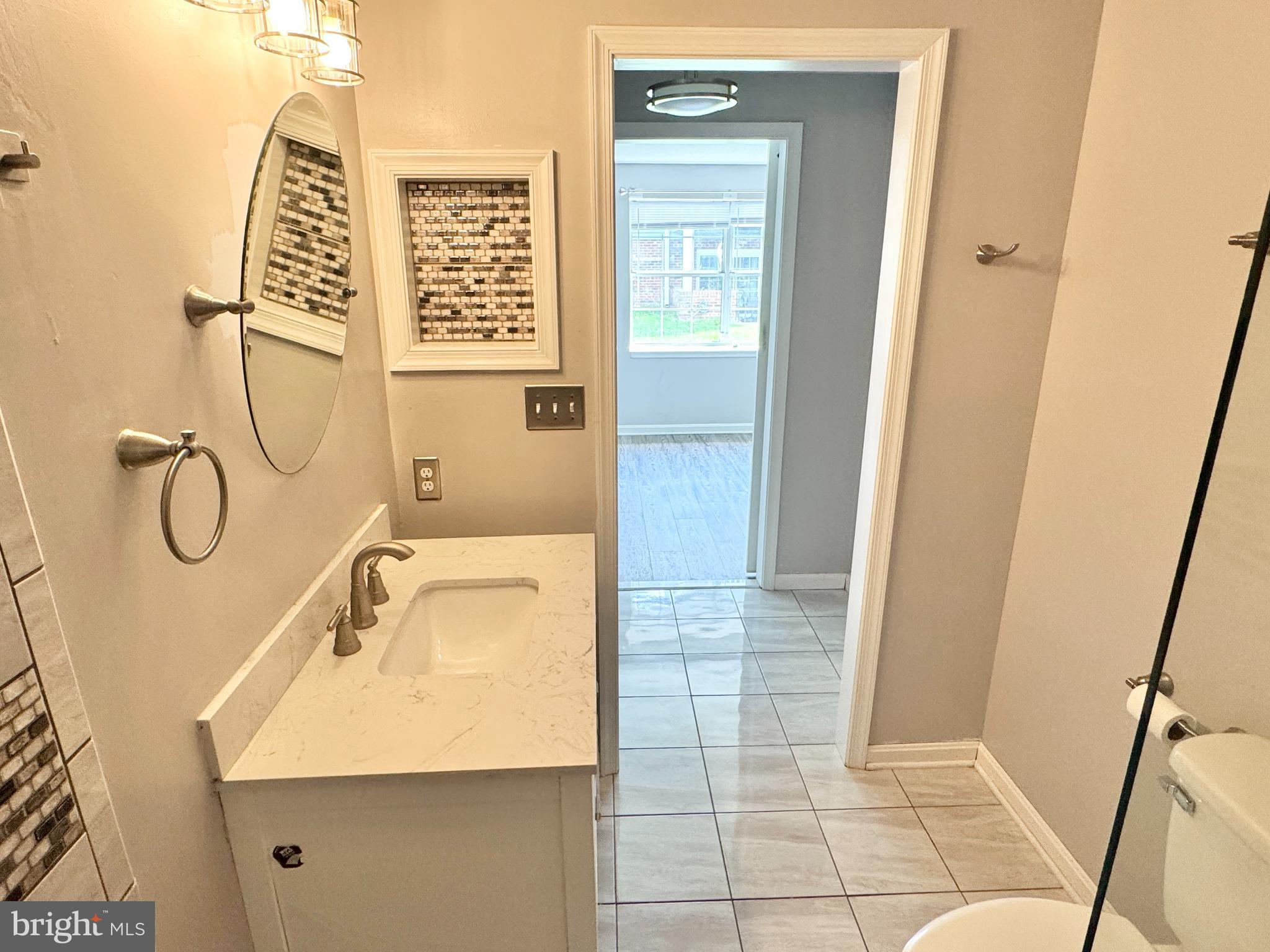 202 Dover Place, Unit 2 Stafford, VA 22556 - Photo 17 of 22 a bathroom with a sink a vanity and window