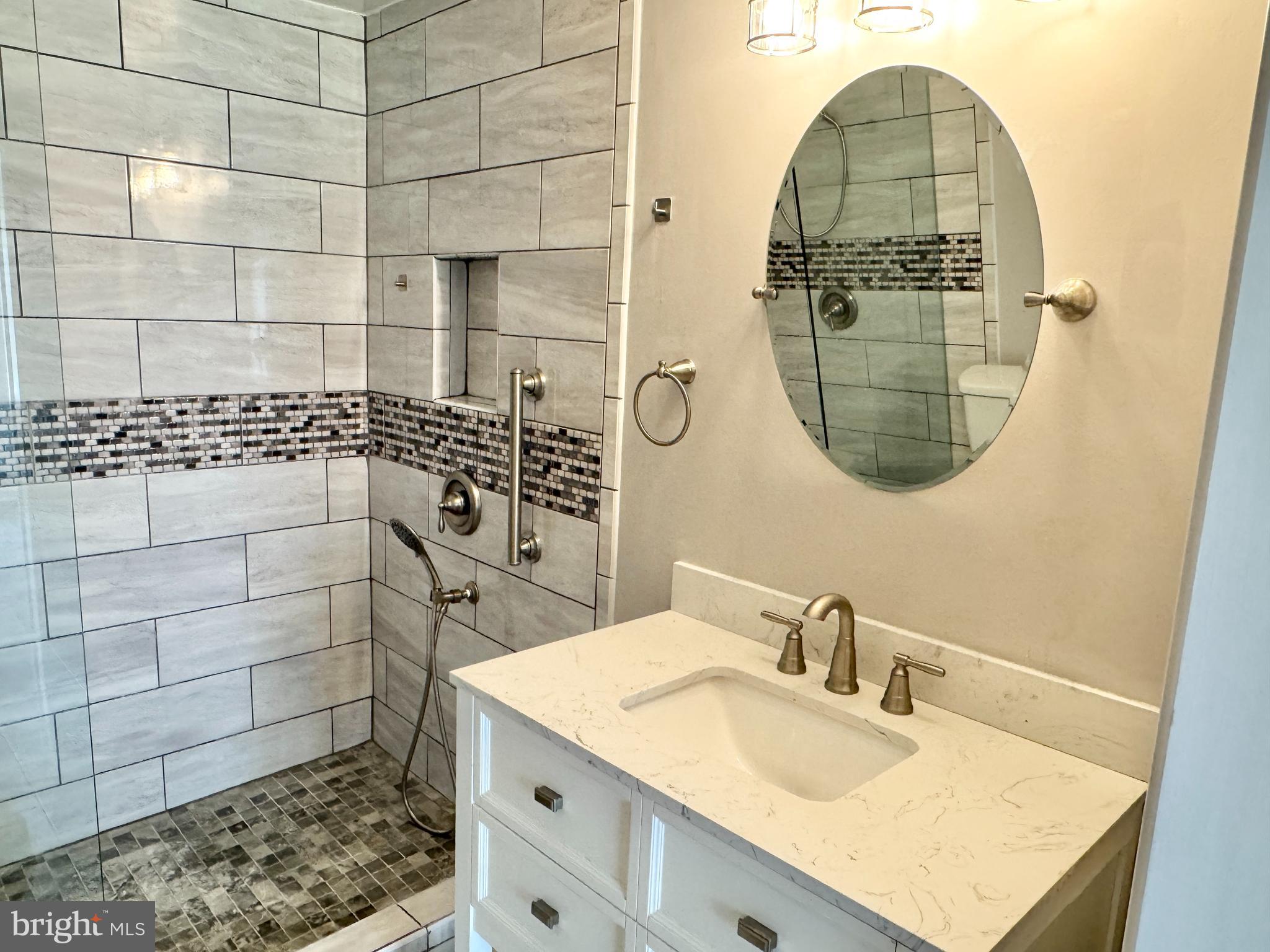 202 Dover Place, Unit 2 Stafford, VA 22556 - Photo 18 of 22 a bathroom with a sink a vanity and a mirror
