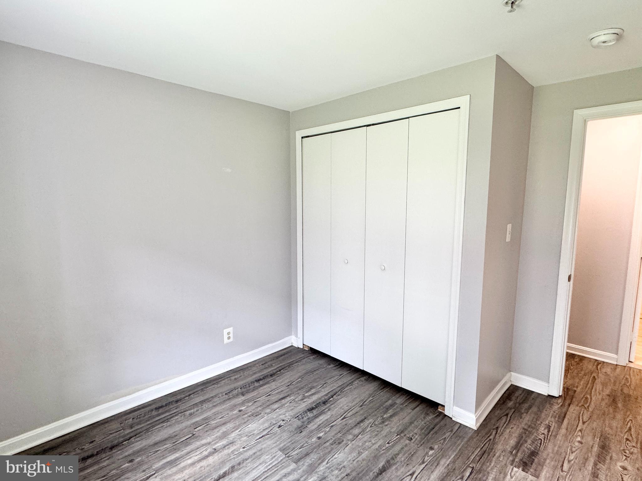 202 Dover Place, Unit 2 Stafford, VA 22556 - Photo 20 of 22 a view of an empty room with wooden floor