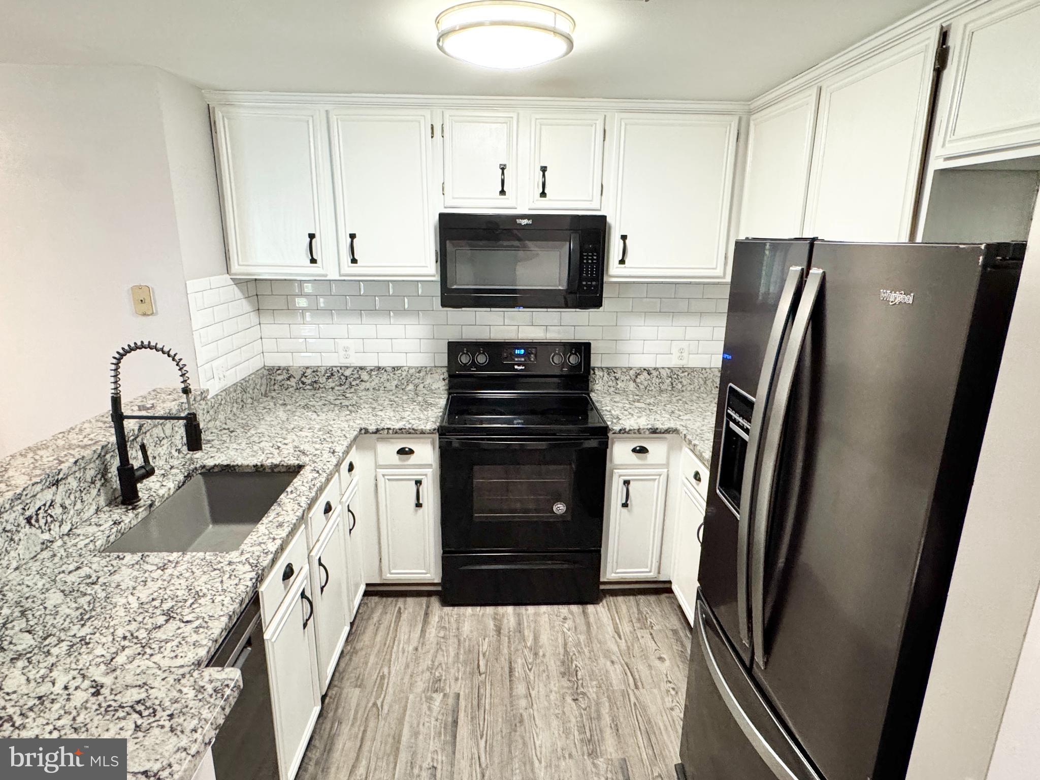202 Dover Place, Unit 2 Stafford, VA 22556 - Photo 3 of 22 a kitchen with stainless steel appliances granite countertop a refrigerator stove and sink