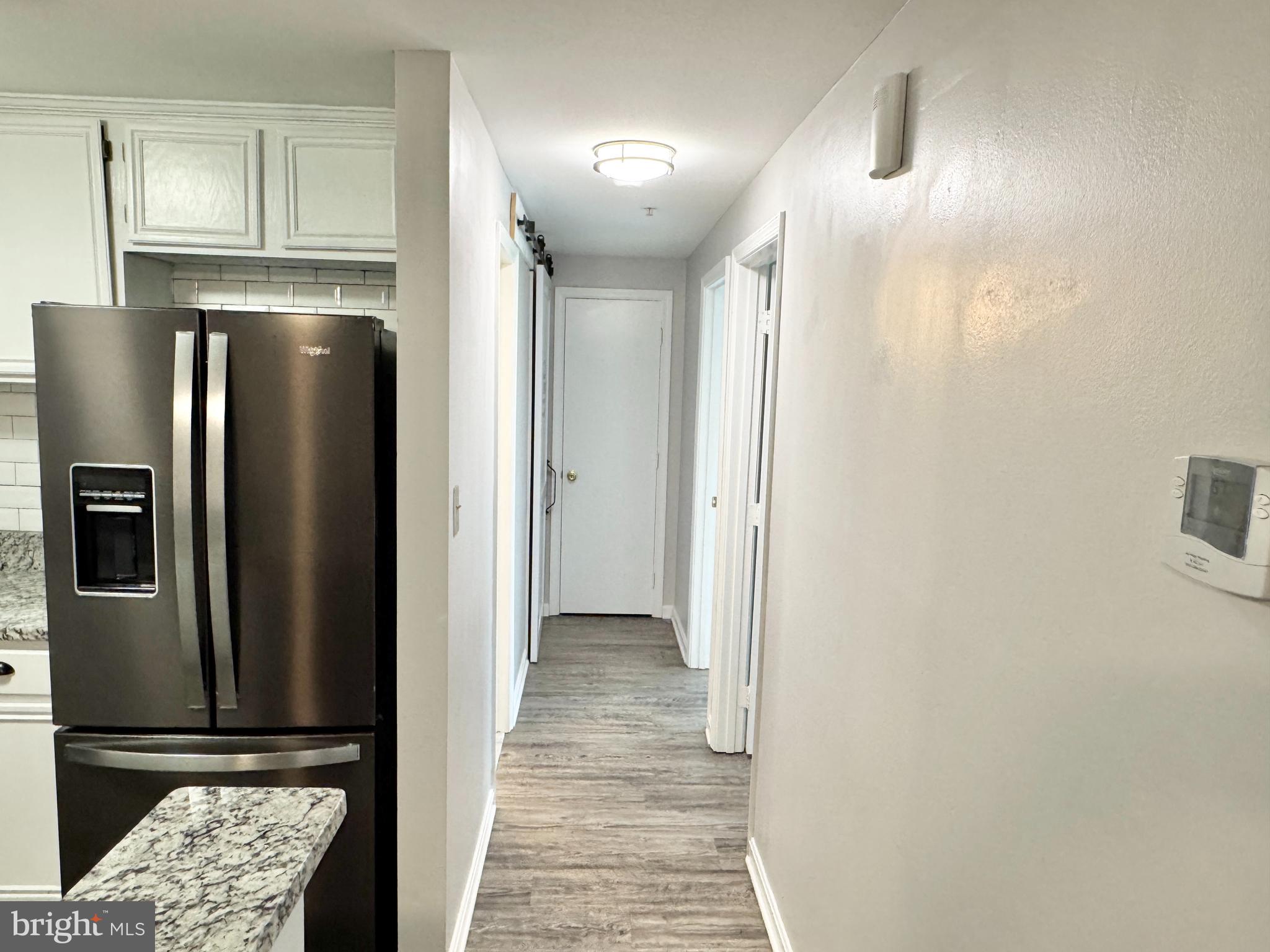 202 Dover Place, Unit 2 Stafford, VA 22556 - Photo 10 of 22 a view of a refrigerator in kitchen and wooden floor