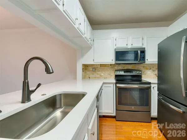 a kitchen with a sink cabinets and stainless steel appliances