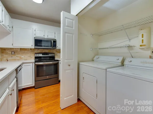 a kitchen with a sink cabinets and stainless steel appliances