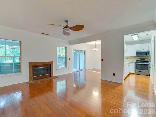a view of a livingroom with furniture a ceiling fan and window
