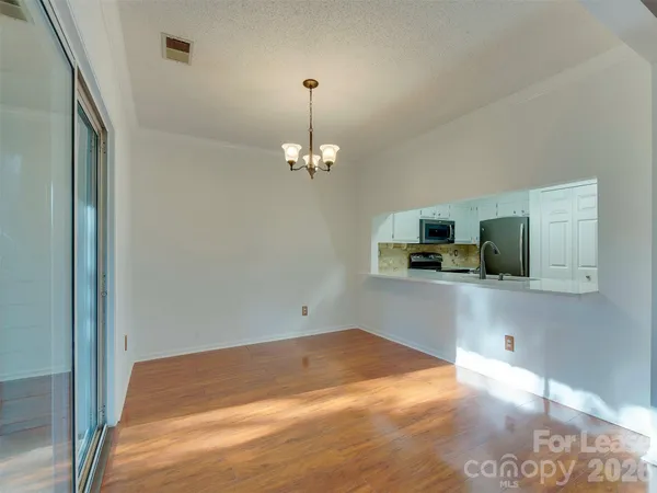 a view of a kitchen with a sink and a refrigerator