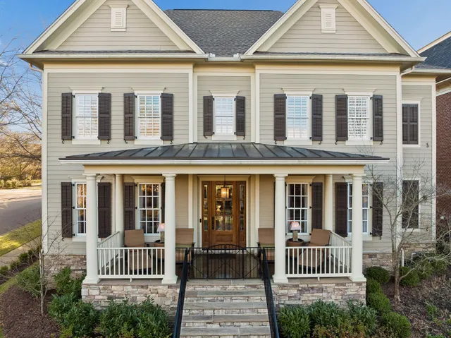 a living room with patio furniture and a large window