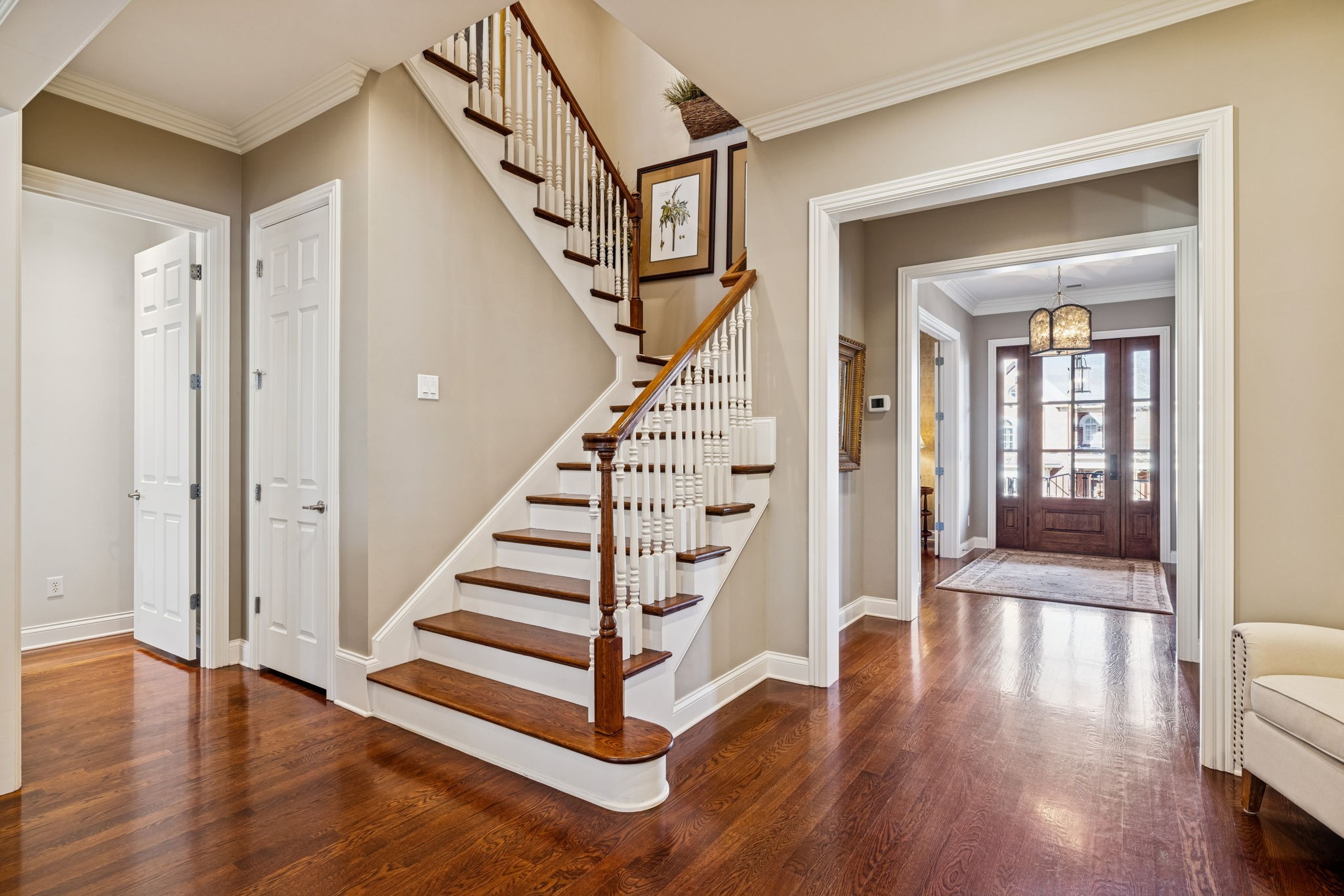600 Pearre Springs Way Franklin, TN 37064 - Photo 19 of 85 a view of a hallway with wooden floor staircase and a living room