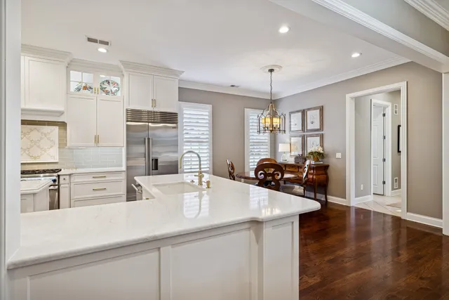 a kitchen with stainless steel appliances kitchen island granite countertop a sink and cabinets