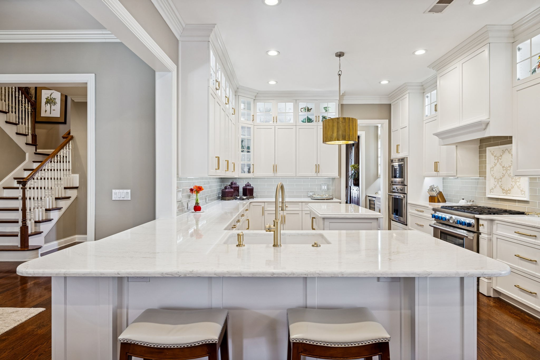 600 Pearre Springs Way Franklin, TN 37064 - Photo 31 of 85 a kitchen with a sink a stove a refrigerator and white cabinets with wooden floor