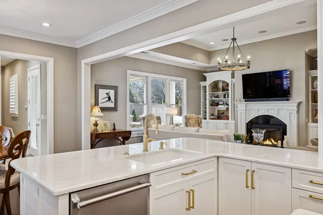 a living room with furniture and floor to ceiling windows